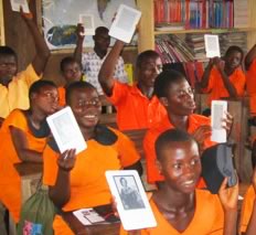 class of Ghana students holding up their KIndle ereaders